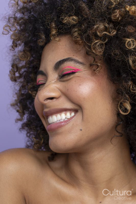 Smiling woman with pink makeup
