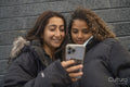 Two young women looking at smartphone