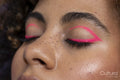 Close up of pink makeup on woman's closed eyes