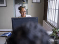 Teenage girl using computer in office