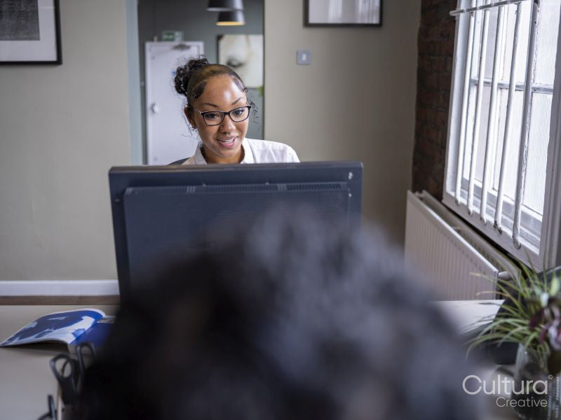 Teenage girl using computer in office