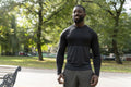 Portrait of smiling athletic man standing in park