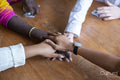 Group of friends holding hands together
