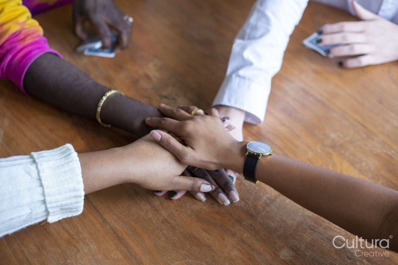 Group of friends holding hands together