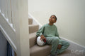 Boy sitting on stairs with soccer ball