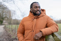 Portrait of man wearing winter jacket in rural setting