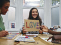 People making protest signs with symbols of peace