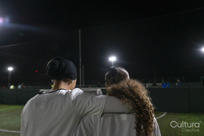 Female soccer players embracing