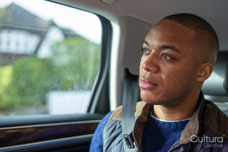 Man sitting in car with buckled seatbelt