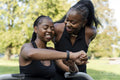 Young female friends exercising in outdoor gym