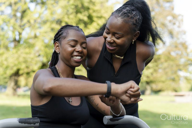 Young female friends exercising in outdoor gym