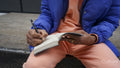 Close up of man writing in diary