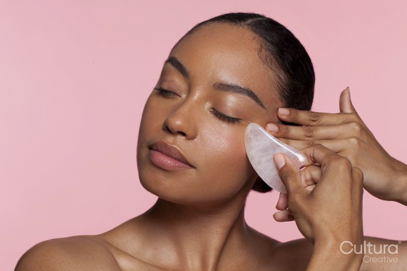 Woman using face massager