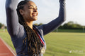 Portrait of female athlete celebrating with medal