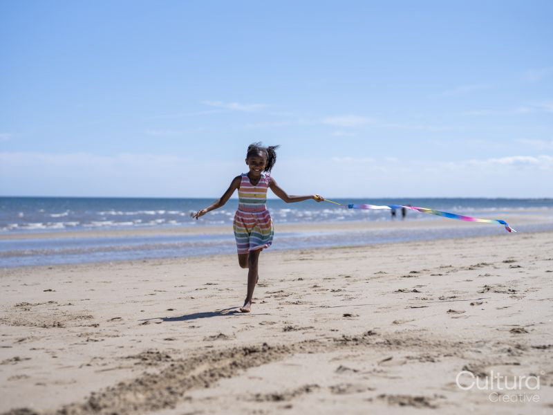 Girl with ballet ribbon on beach