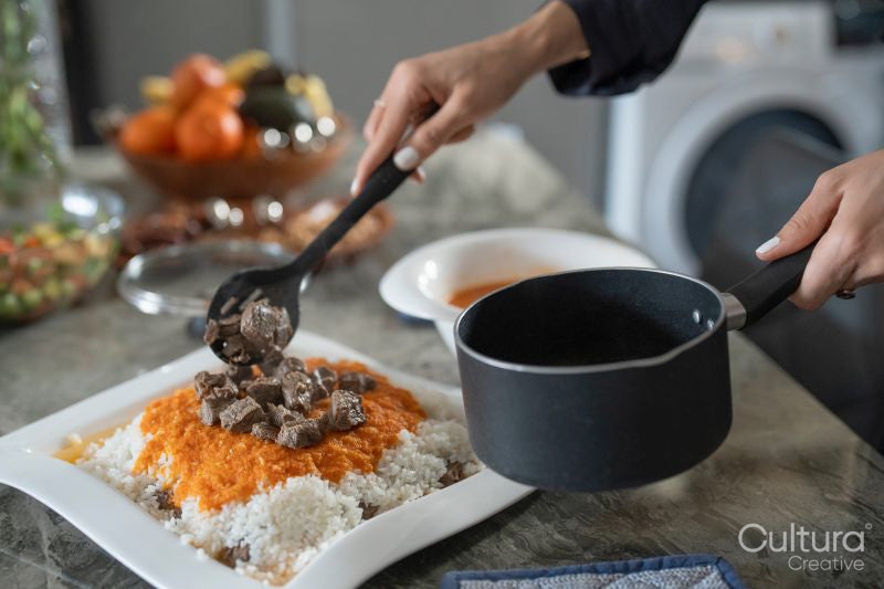 Mid adult woman putting food on plate