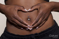 Woman making hand heart gesture on abdomen