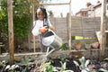 Girl watering plants in garden