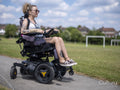 Woman in electric wheelchair going on walk