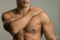 Mid section of shirtless muscular man