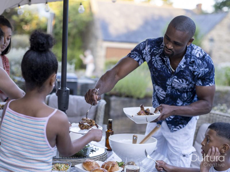 Family with children having barbecue