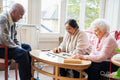 Senior people playing domino in nursing home