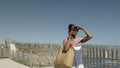 Senior woman talking on phone on beach