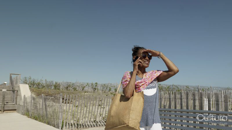 Senior woman talking on phone on beach