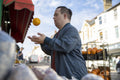 Man examining fruit in grocery store