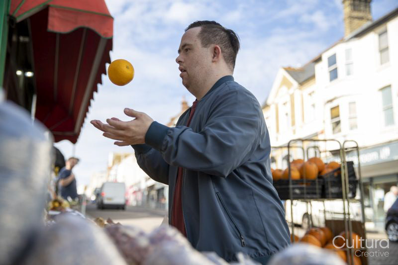 Man examining fruit in grocery store