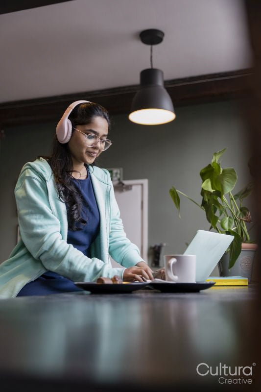 Female student using laptop while studying