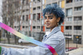 Portrait of smiling young woman holding colorful ribbon