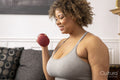 Woman exercising with dumbbells in living room