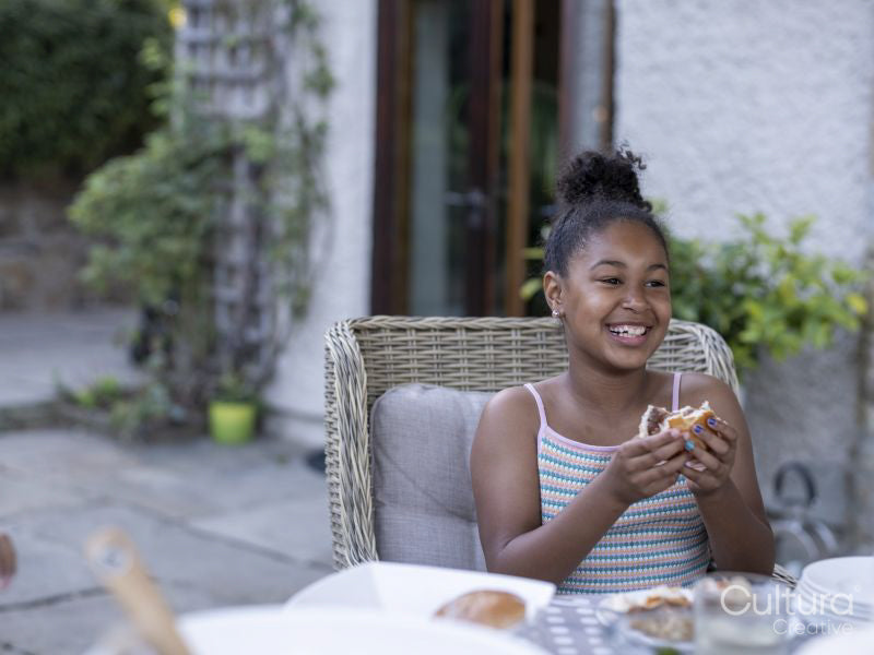 Smiling girl eating hamburger