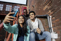 Group of young people taking selfie on stairs
