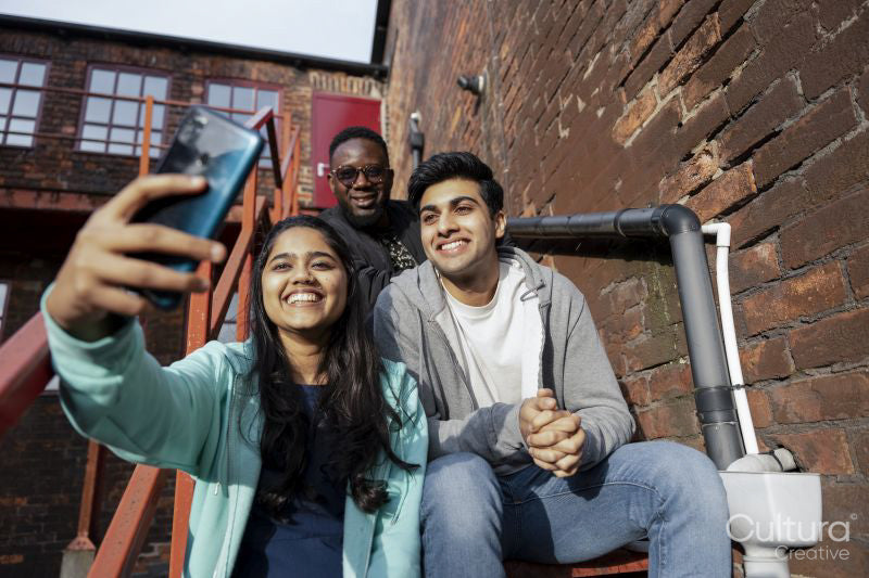 Group of young people taking selfie on stairs