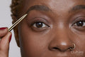 Close-up of woman with tweezers