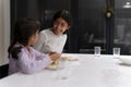 Sisters eating meal at table