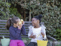Girl friends with baskets on Easter egg hunt