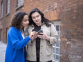 couple looking at smart phone on street