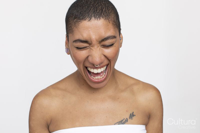 Studio portrait of woman with nose ring laughing