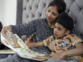 Mother and son reading book in bed