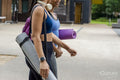 Female friends walking with yoga mats
