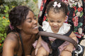 Mother going for walk with baby daughter in stroller