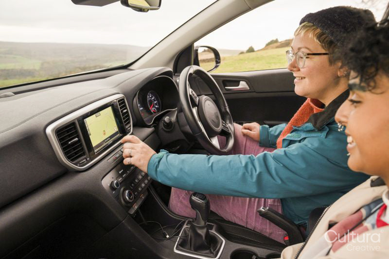 Female friends using GPS in car