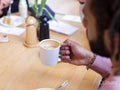 Young man holding coffee cup, close up