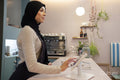 Young woman in hijab working in cafe