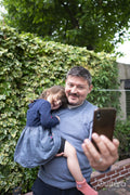 Smiling man taking selfie with daughter outdoors