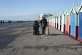 Father and disabled son strolling with dog