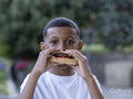 Portrait of boy eating hamburger